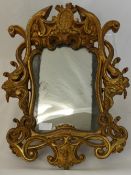 An Antique Wooden Gilt and Plaster Mirror, the ornate mirror having crown and flag to top with