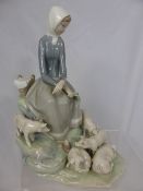 A Porcelain LLadro figure featuring a young woman and piglets, 28 cms high.