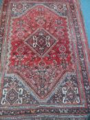 A Vintage Middle Eastern Woollen Rug, the rug having a single central ghoul with animal motif to
