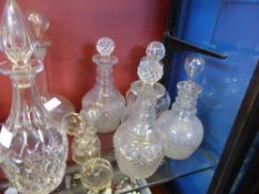 A collection of miscellaneous cut glass decanters including pair of antique collared decanters and a