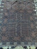An Antique Middle Eastern Rug with four square ghouls and geometric design 163 x 128 cms.