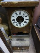 A wooden cased time clock by The National Time Recorder Co. Ltd. St Mary Cray, Kent