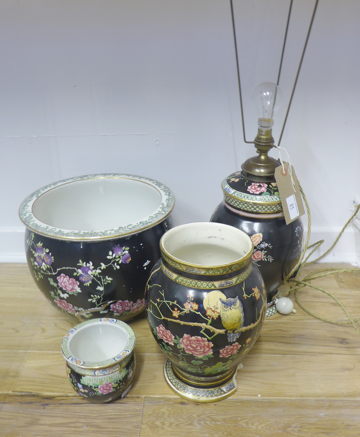 Cetem Ware black glazed and floral decorated jardiniere together with a similarly decorated table