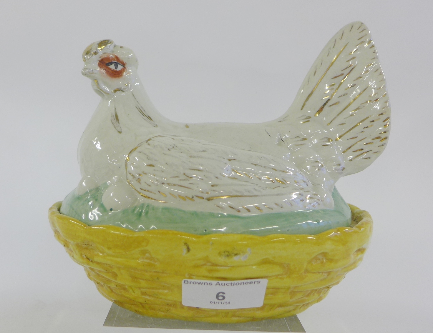 A 19th century Staffordshire pottery hen on nest, 21cm long