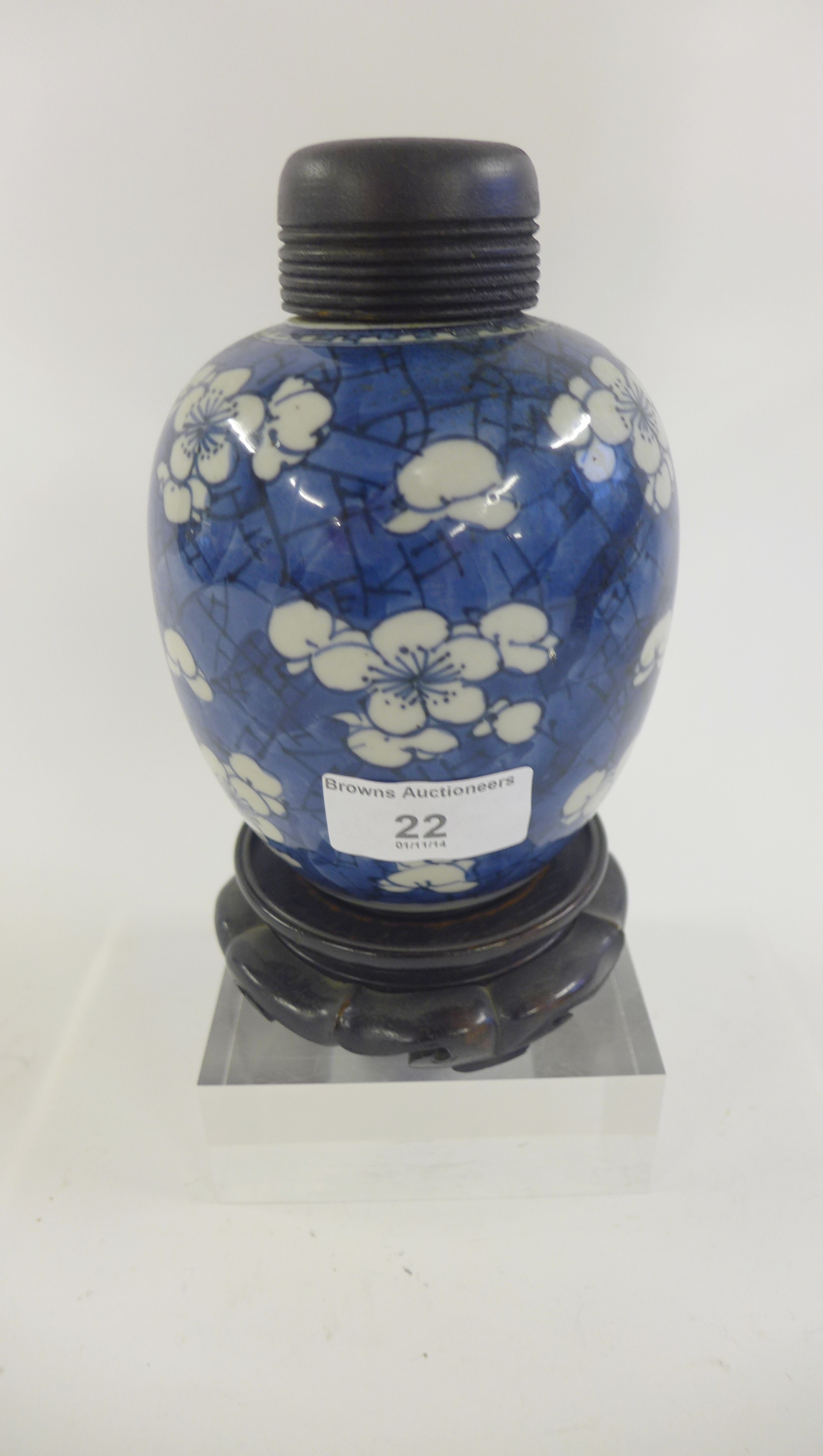 A Chinese blue ground prunus decorated jar, likely 18th century with paper label verso, complete