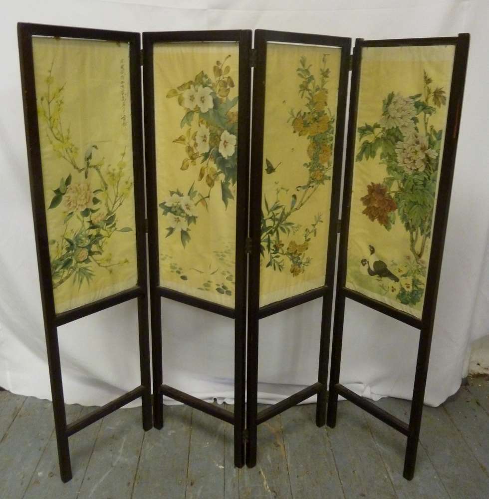 A Victorian ebonised folding screen the panels decorated with Chinese paintings of birds and