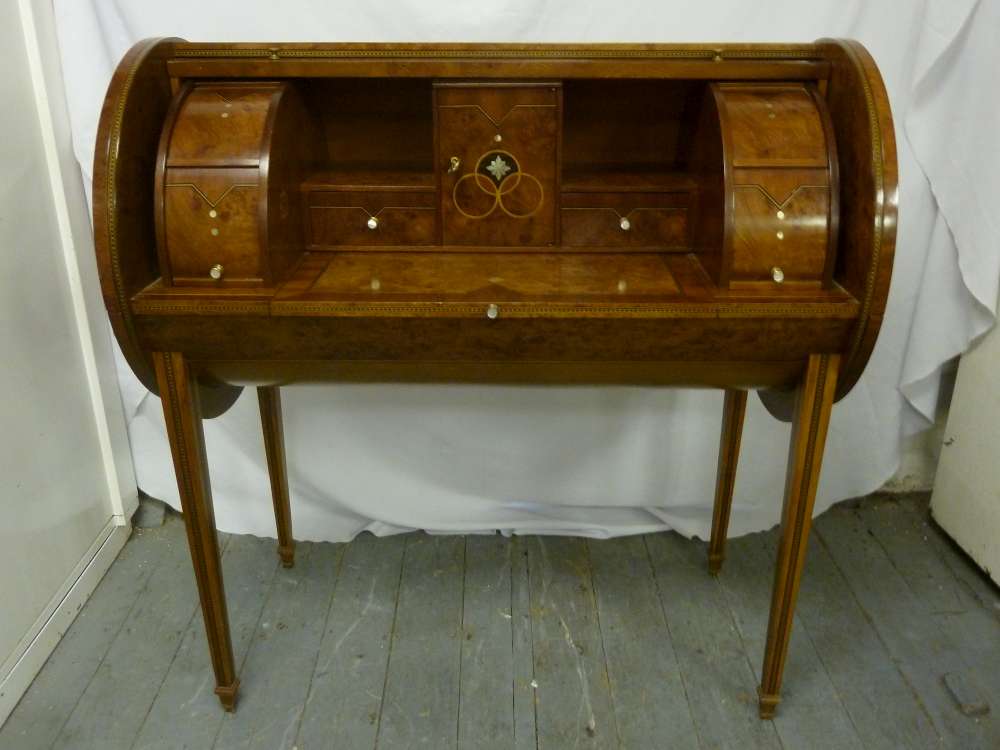 An Italian mid 20th Century cylinder desk with revolving top and fitted interior on four tapering