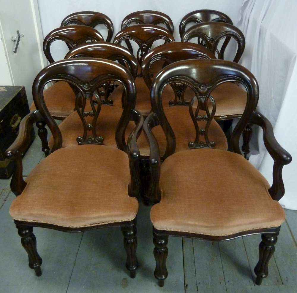 A Victorian set of ten mahogany dining chairs, to include two carvers, pierced oval backs on fluted
