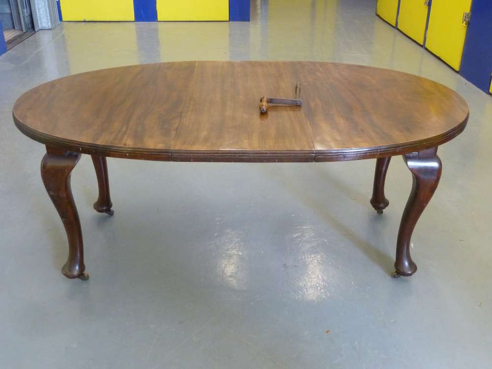 Mahogany oval dining table with one drop in leaf and Joseph screw