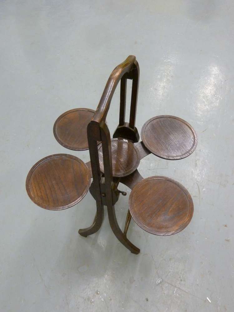 An Edwardian oak plate stand with swing out sides