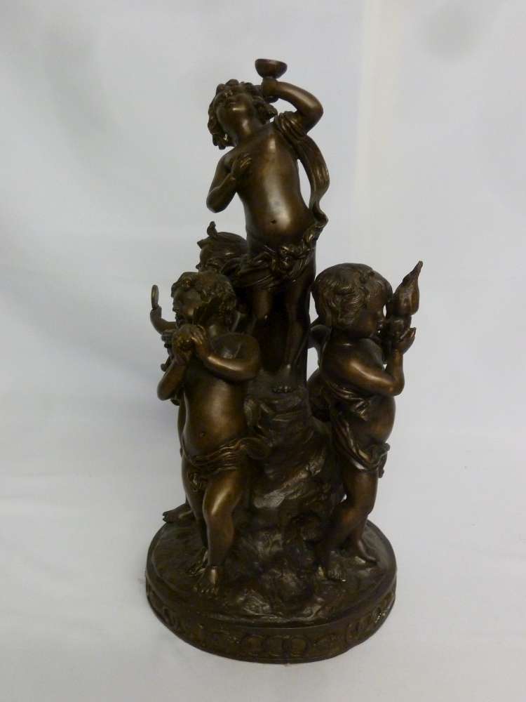 Bronze figural group of putti playing musical instruments