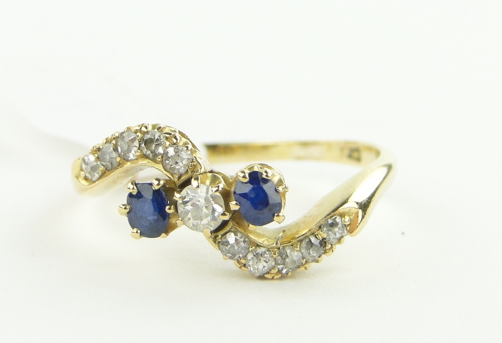 Edwardian 18ct gold sapphire and diamond set crossover ring, size S.