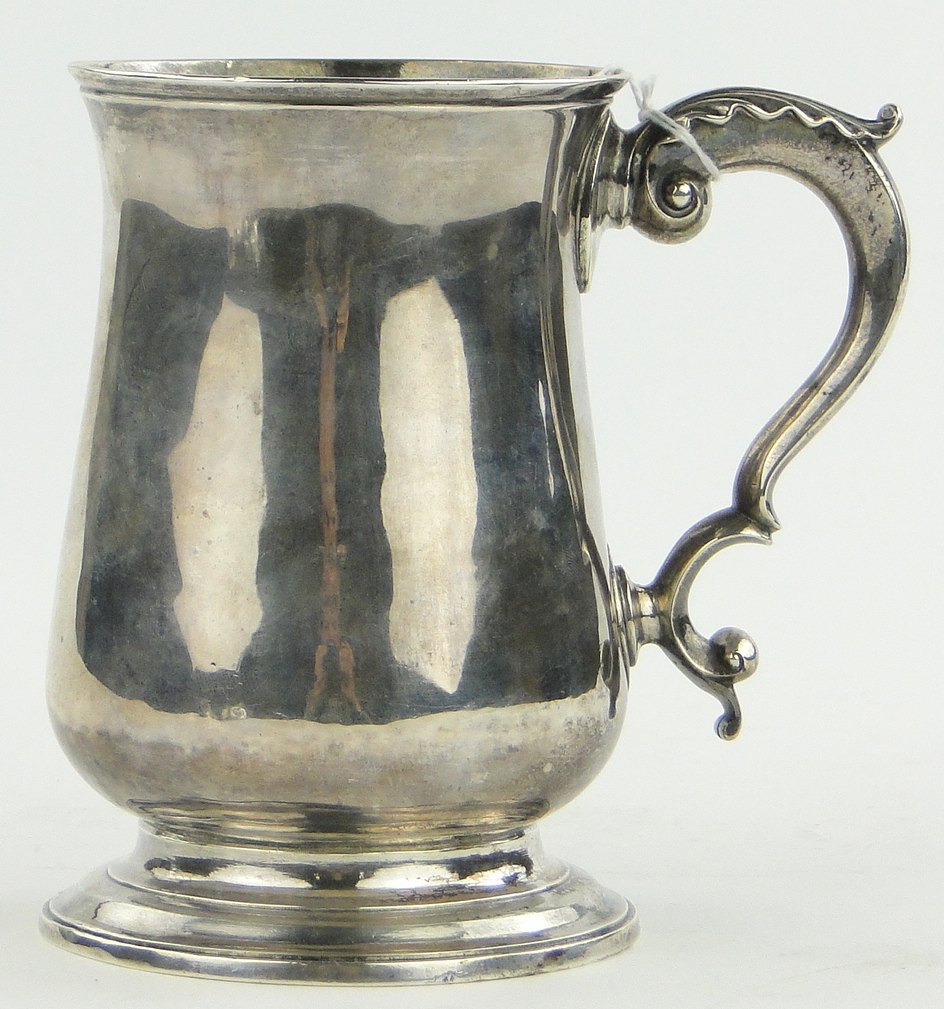 A George III silver pint mug,
of bulbous circular form with acanthus scroll handle, makers marks S