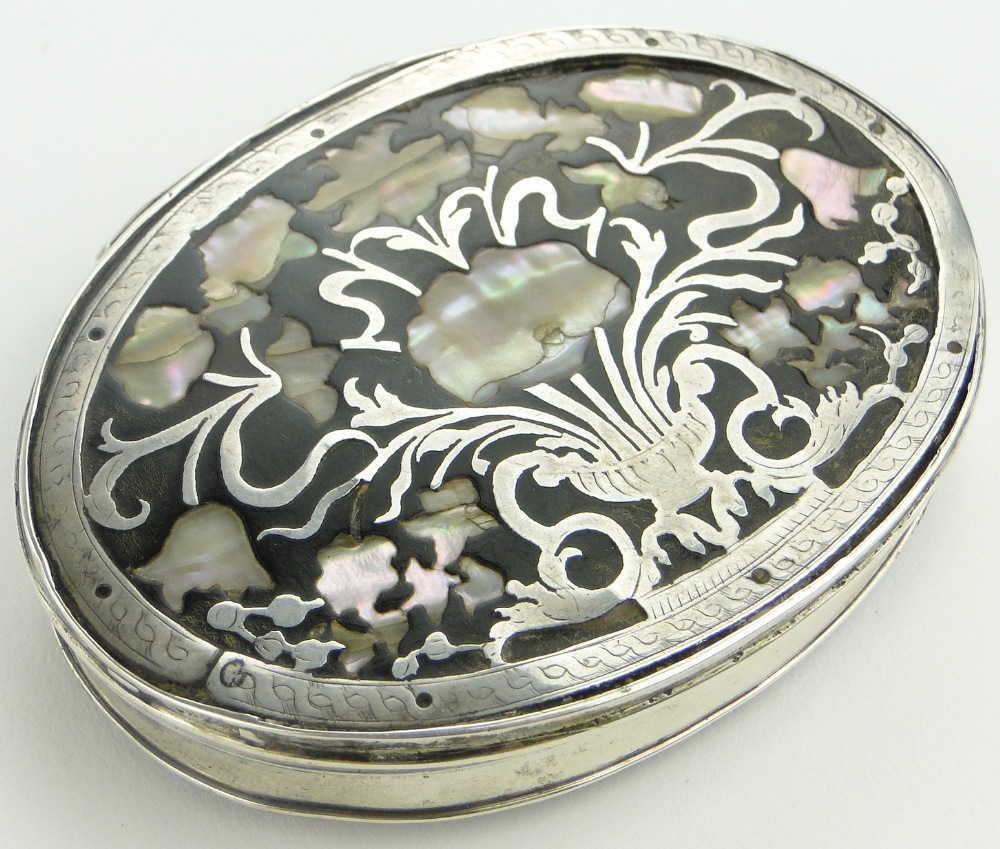 A 17/18th century unmarked white metal box of oval form with mother of pearl and tortoise shell