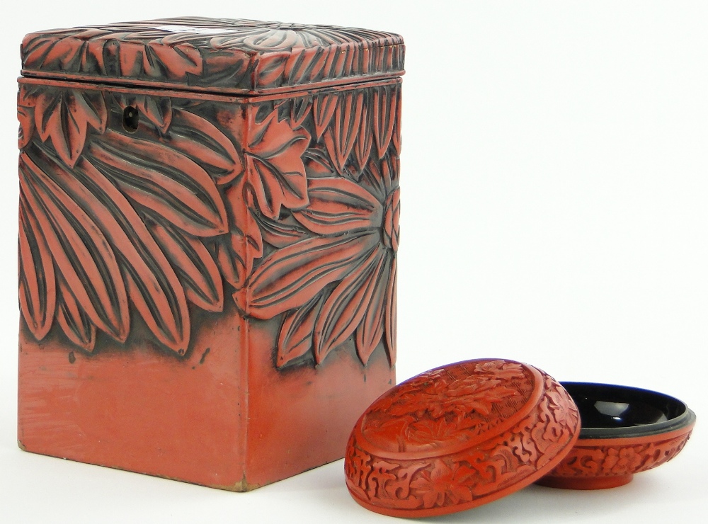 A cinnabar caddy with flower head design, 7.75" and a circular box, (2).