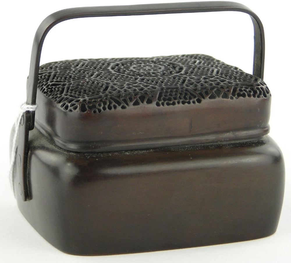 A bronze incense burner and cover with swing handle, length 3.5".