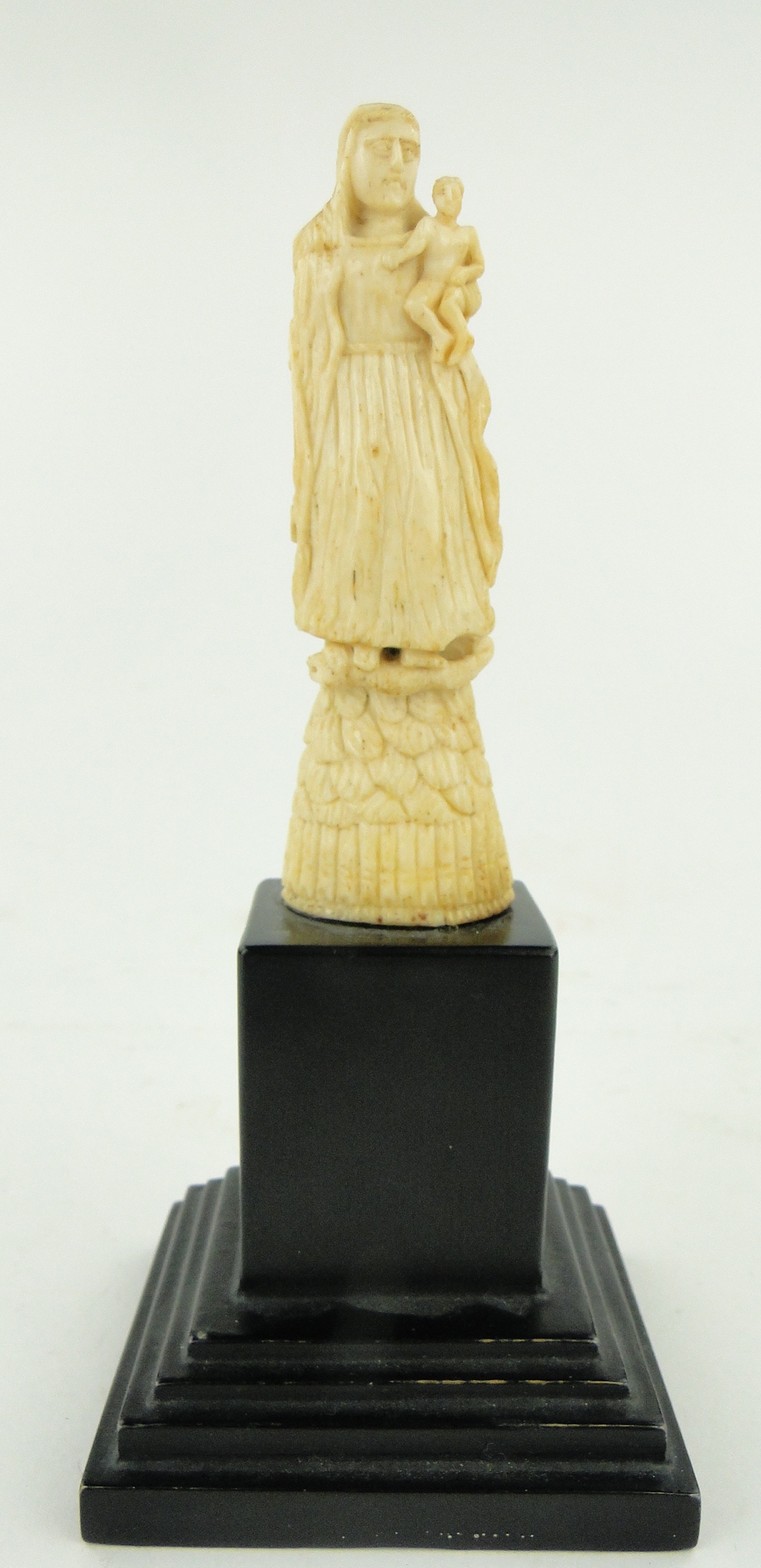 An early Goanese ivory figure of the Madonna and child, on wooden plinth, height 6" overall.