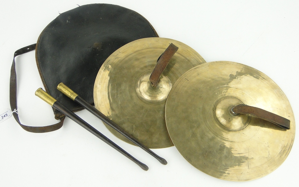 A pair of cymbals and sticks in leather case.