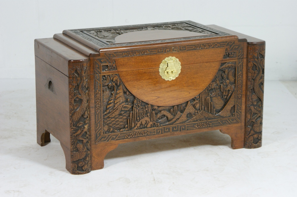 Cantonese carved camphorwood chest, early 20th Century, the lid carved with figures, sailing boats