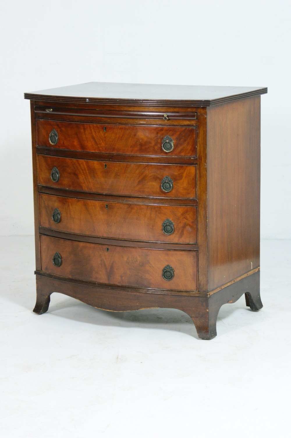 Mahogany bachelor's chest, 20th Century, bow fronted with pull out brushing slide, and four