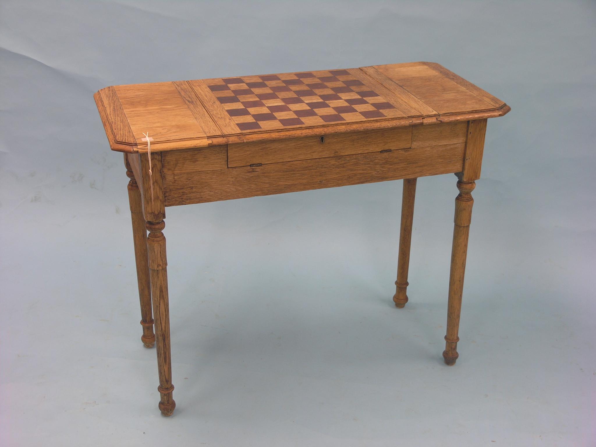 An unusual, early 20th century oak desk, with hinged and inlaid games board, hinged ends enclosing