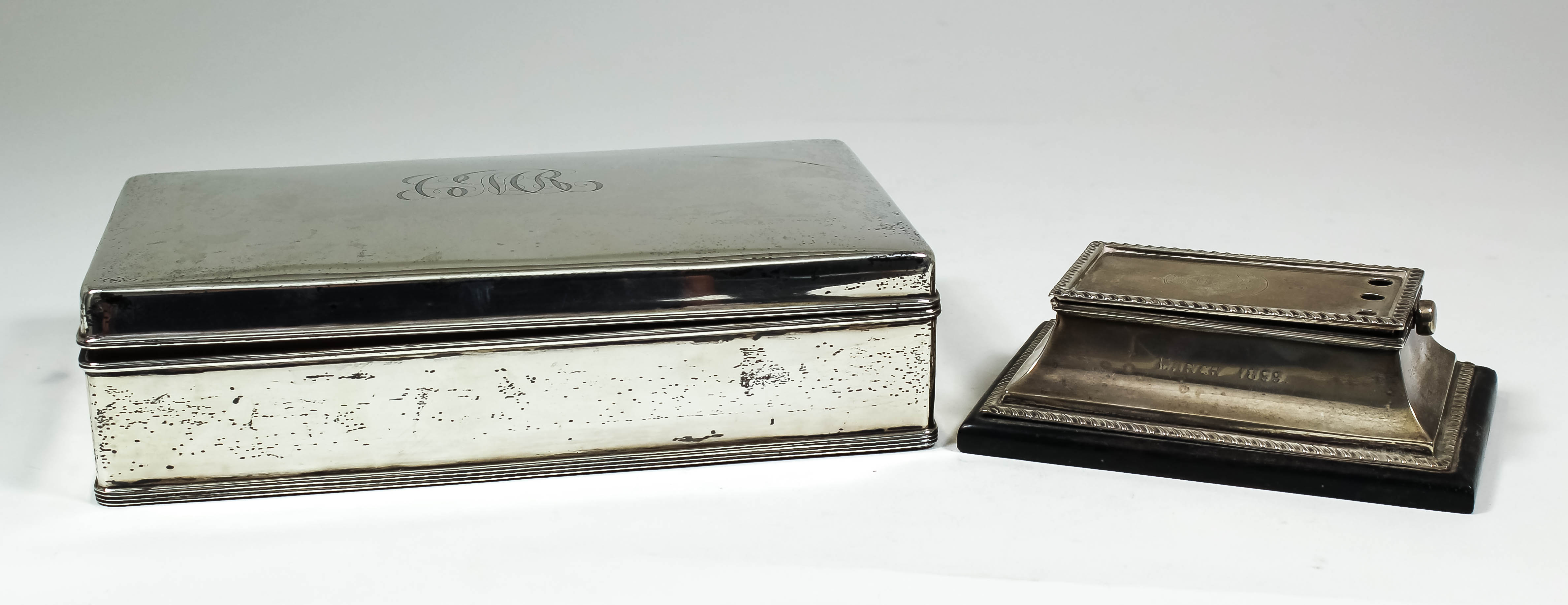 An Edward VII silver rectangular cigarette box, 9.25ins x 5.25ins x 2.25ins high, by The Goldsmiths