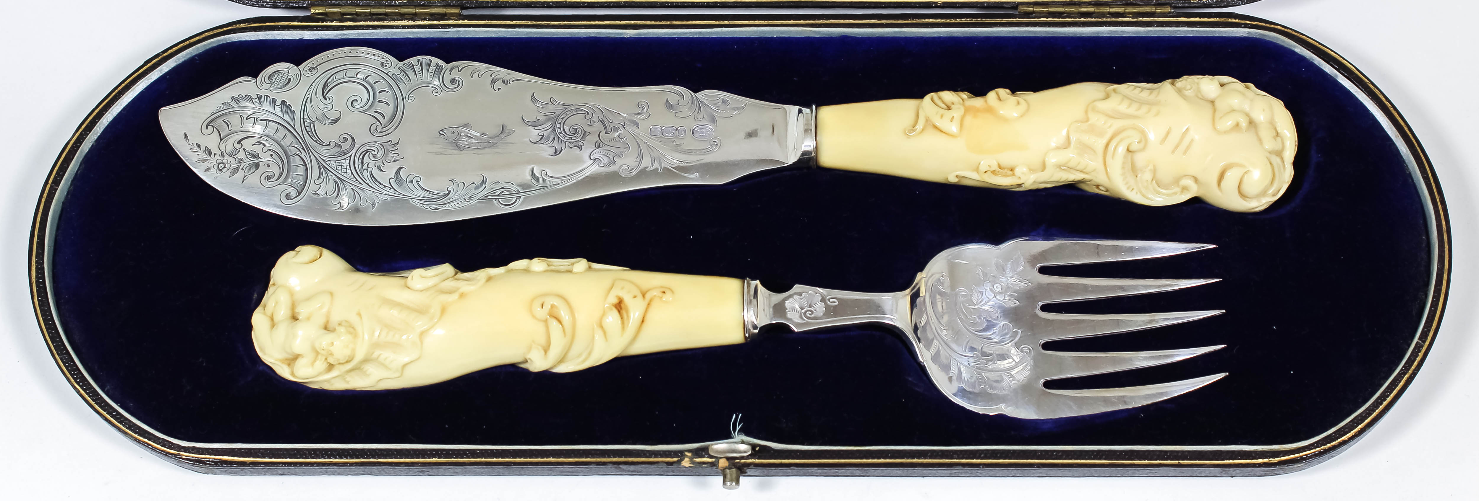 A pair of late Victorian silver and ivory handled fish servers, the blades engraved with fish,