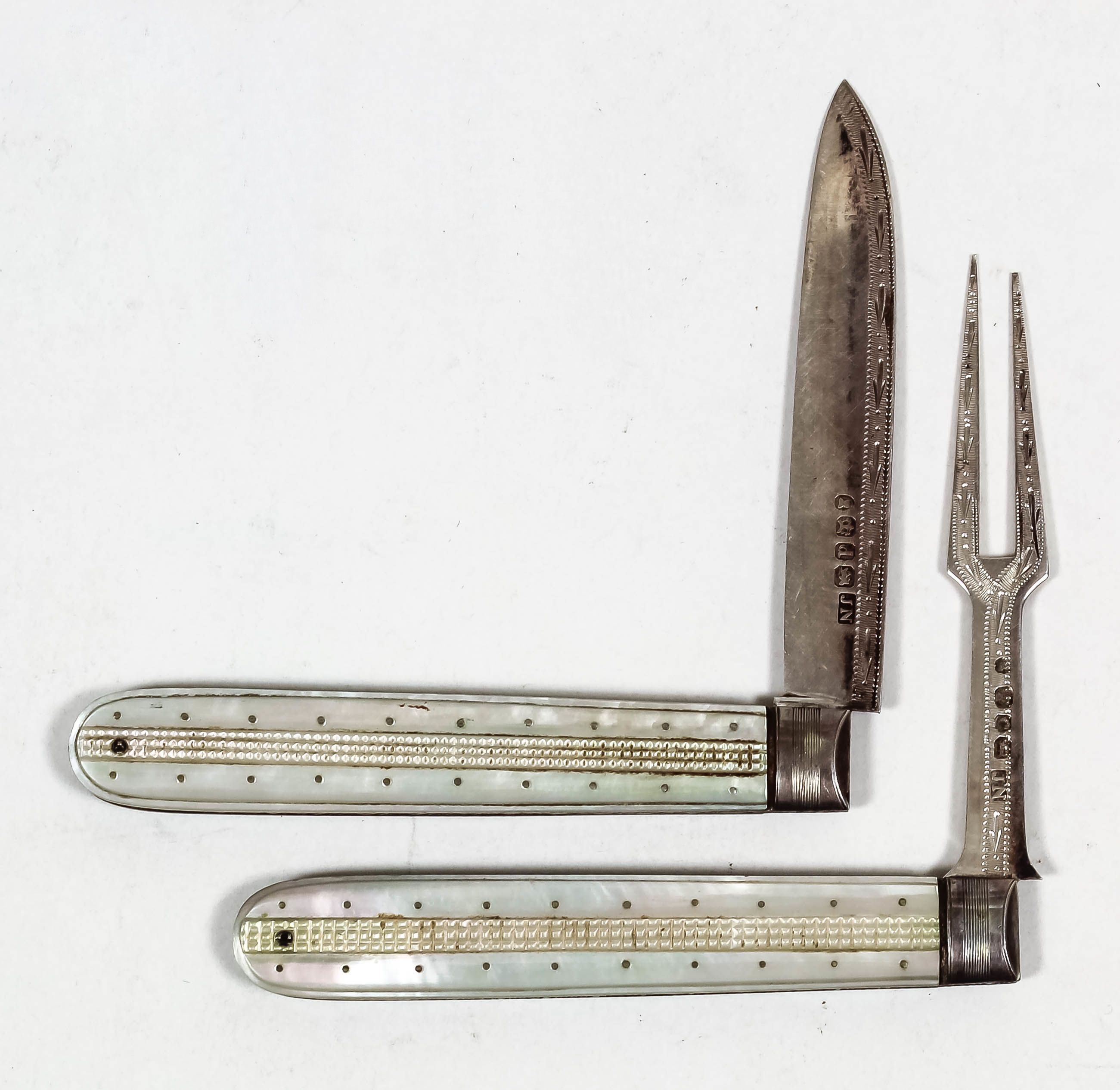 A George IV silver mother of pearl handled pocket fruit knife and fork with cross hatch and pique