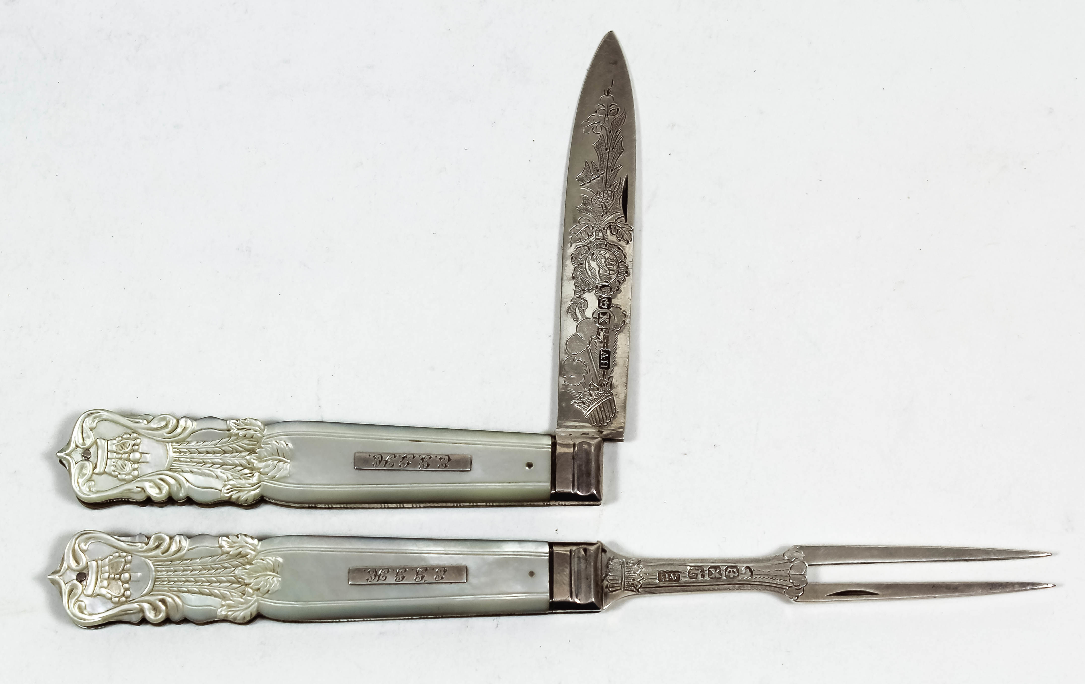 A Victorian silver and mother of pearl handled pocket fruit knife and fork, the blades engraved