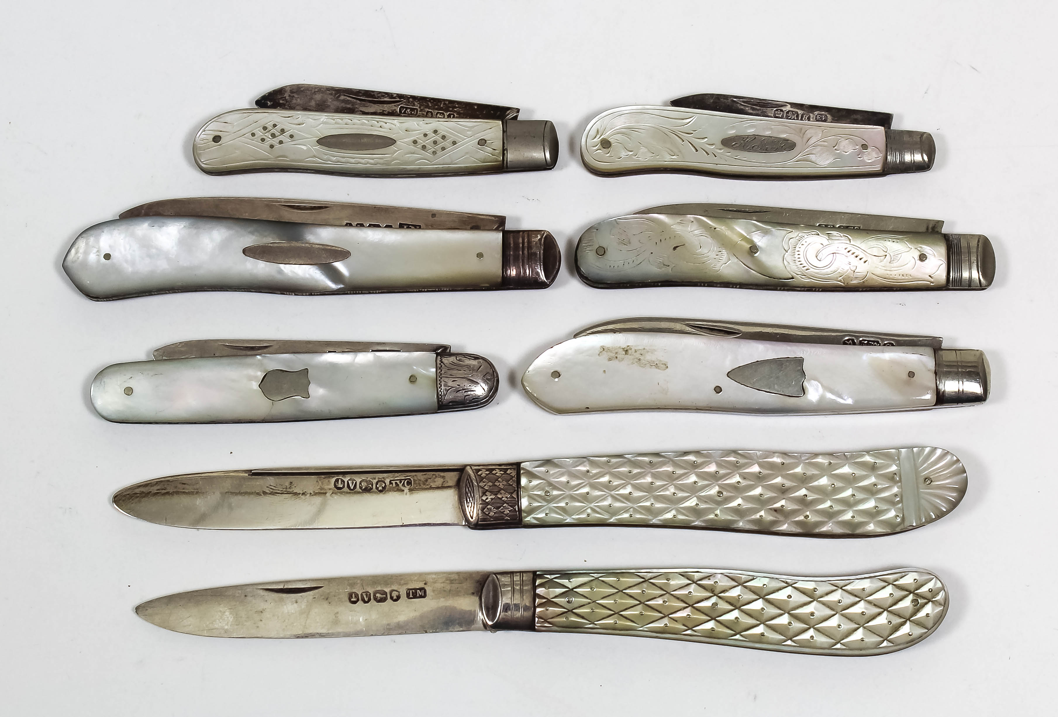 Two Victorian silver and mother of pearl handled pocket fruit knives, the pistol grip handles with