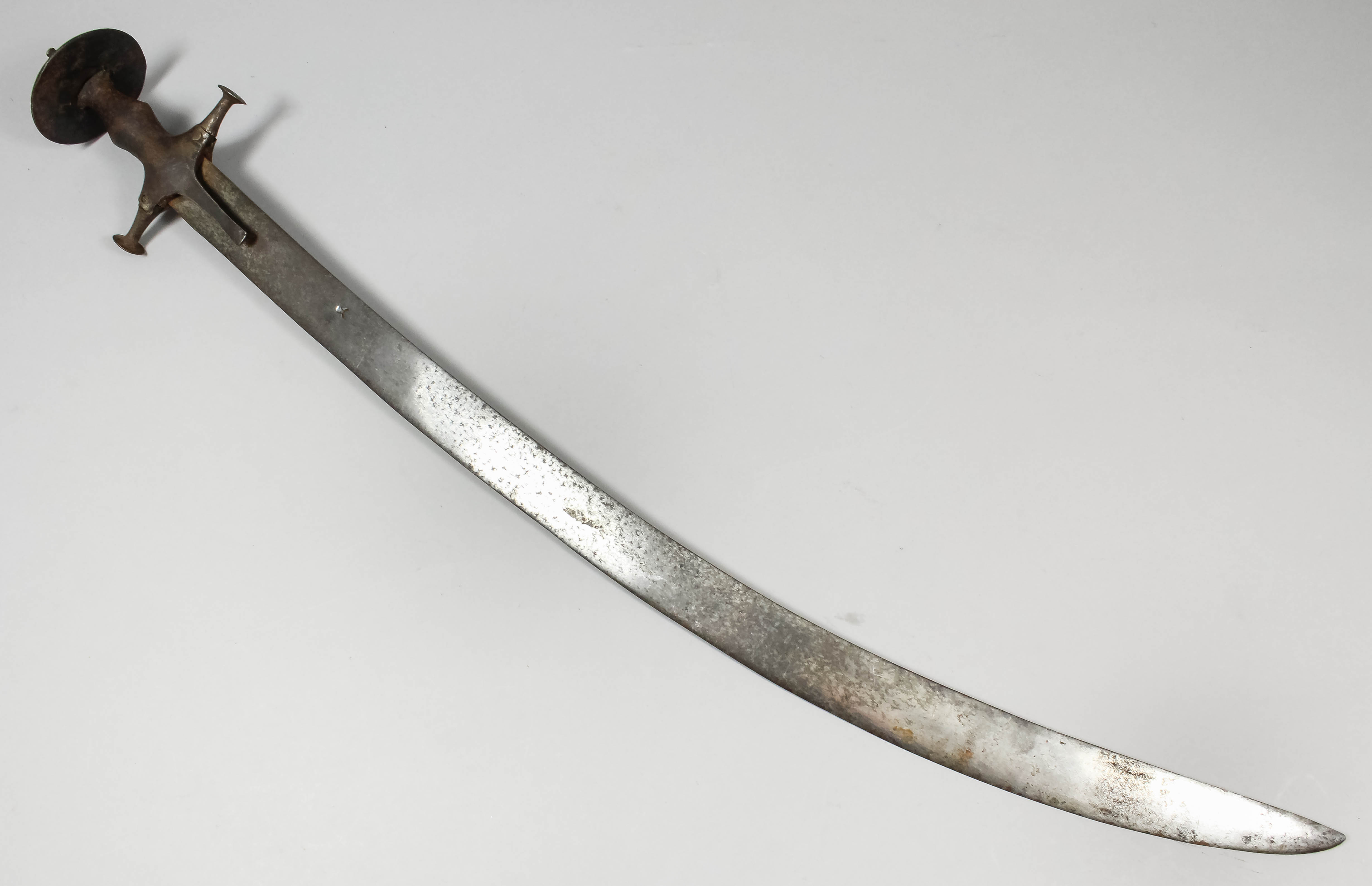 A 19th Century Indian Talwar, the 29ins curved blade bearing armoury mark and with steel hilt and