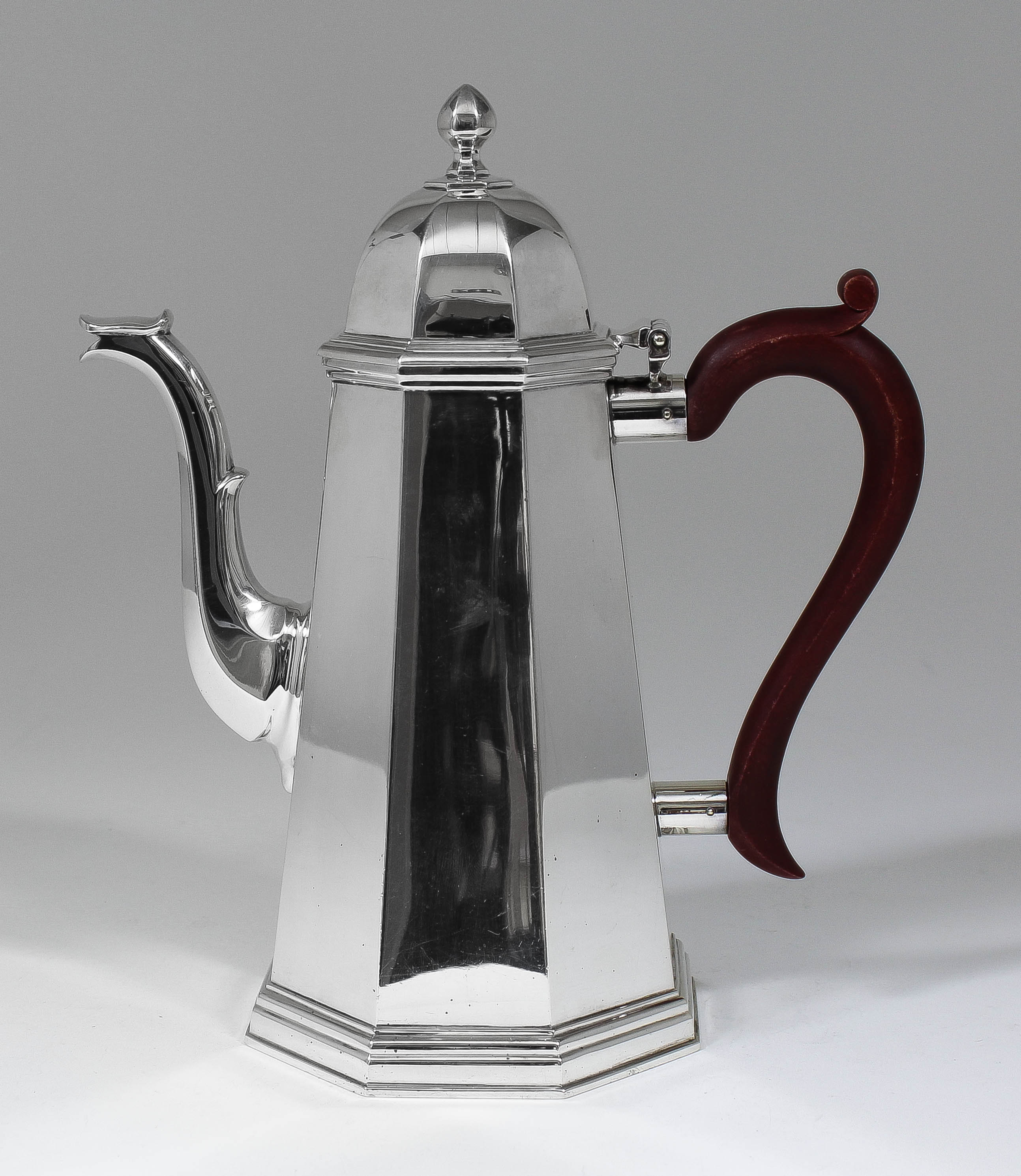 An Elizabeth II silver octagonal coffee pot of 18th Century design with tapered body, domed lid and