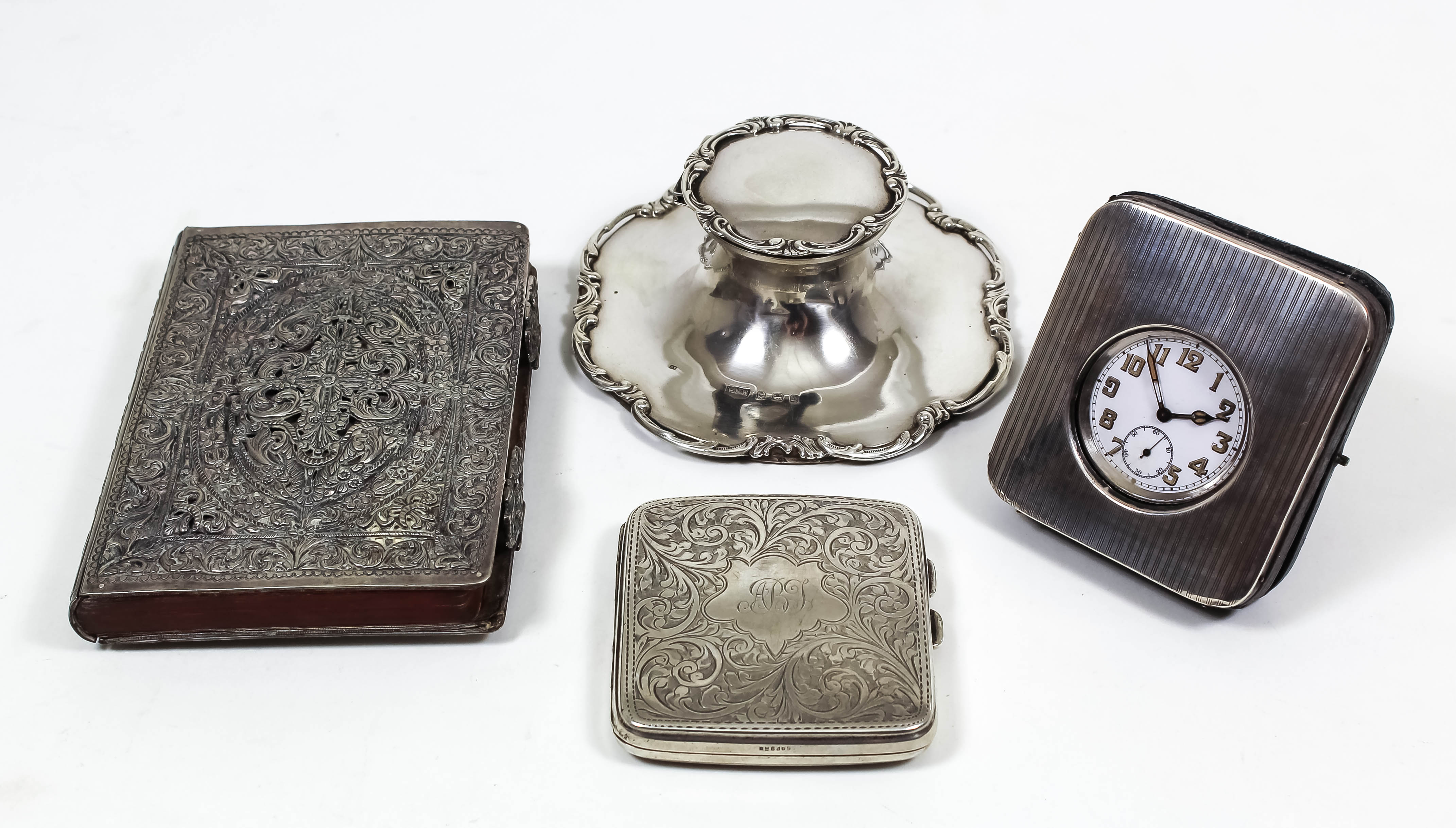 An Edward VII silver capstan pattern inkwell with bold leaf and C-scroll mounts, 5.25ins diameter,