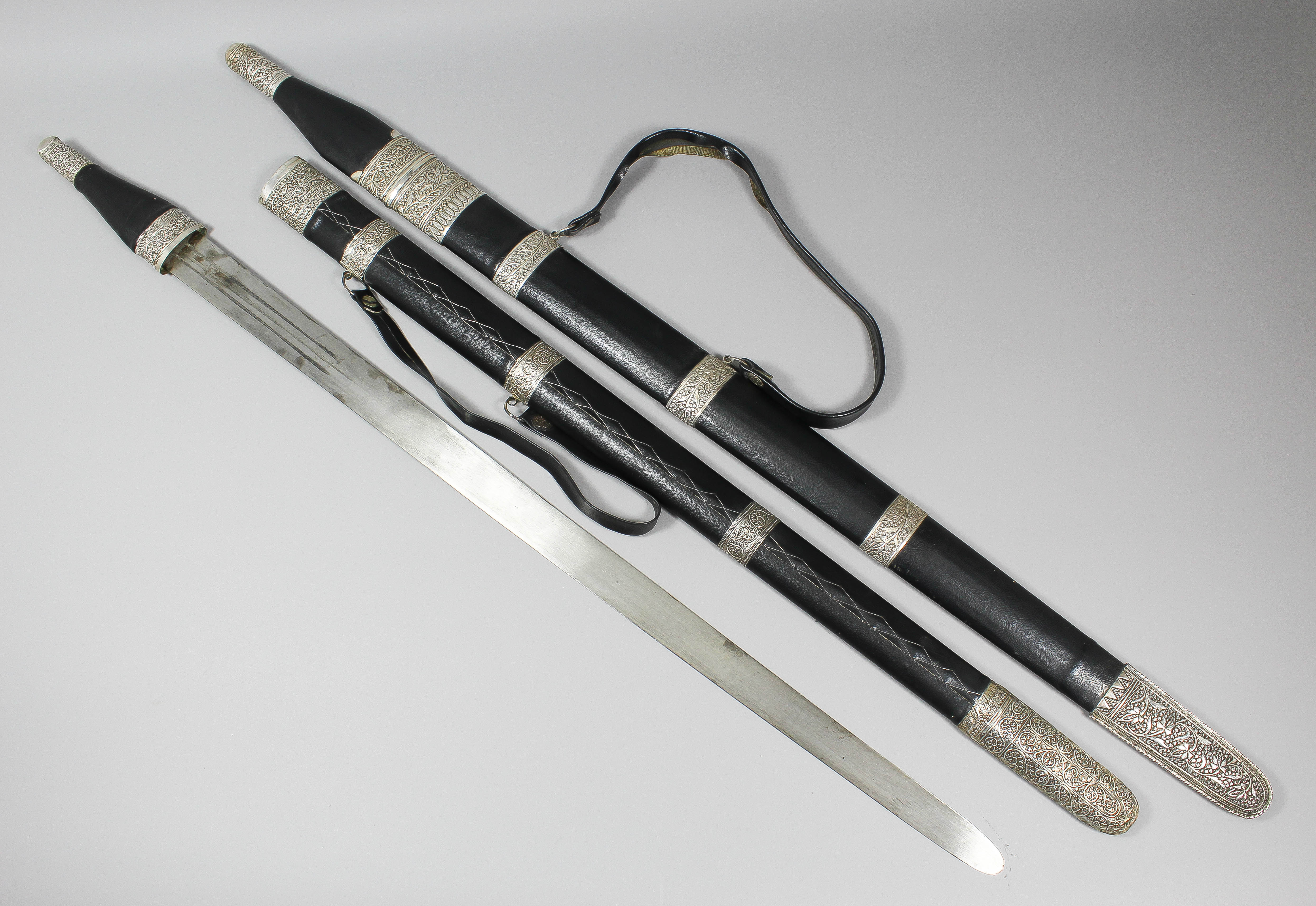 A late 20th Century Omani Kattara sword, the 27.5ins blade with three central fullers to either