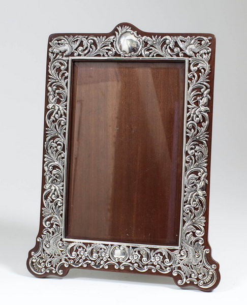 A late Victorian silver rectangular photograph frame, pierced and cast with leafage, birds and