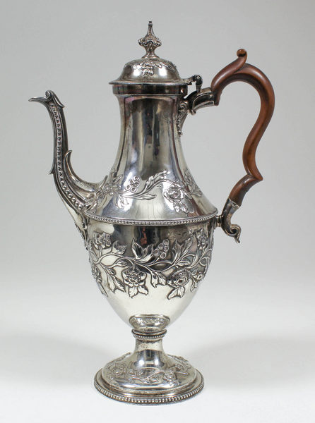 A George III silver coffee pot with embossed floral ornament, bead mounts and with fruitwood