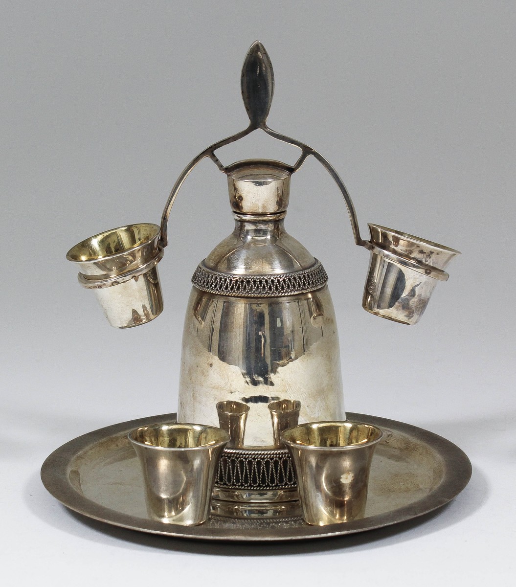 A late 19th/early 20th Century Russian silvery metal vodka decanter of bulbous form with two