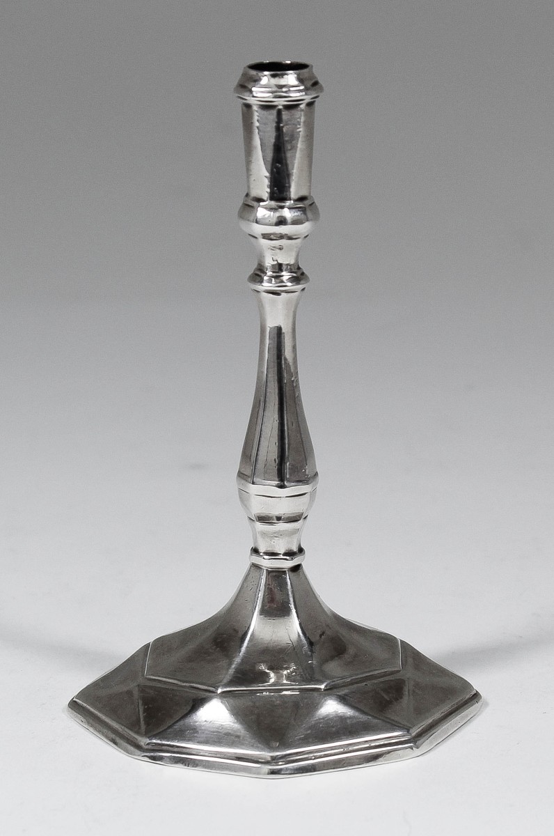 A George I cast silver taper stick with octagonal baluster column and octagonal faceted foot, 5ins