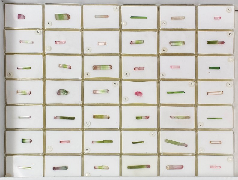 Tourmaline - A similar lot of eighty-four pink and green tourmaline crystals in plastic boxes,