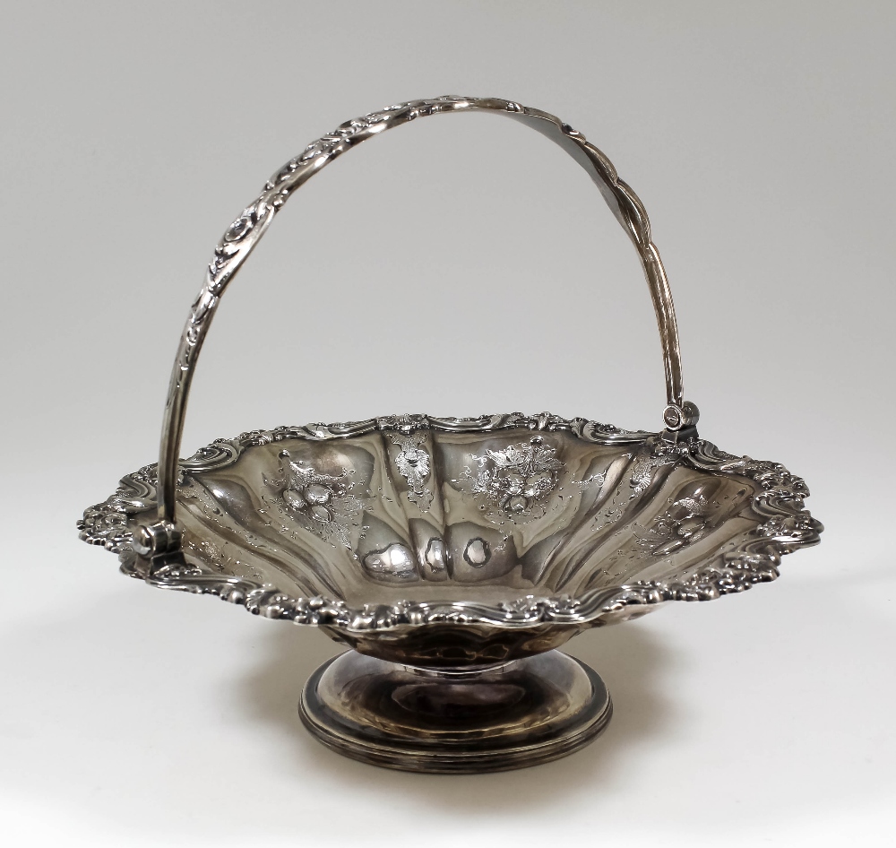 A Victorian silver circular basket of shaped outline, the rim cast and the sides engraved and