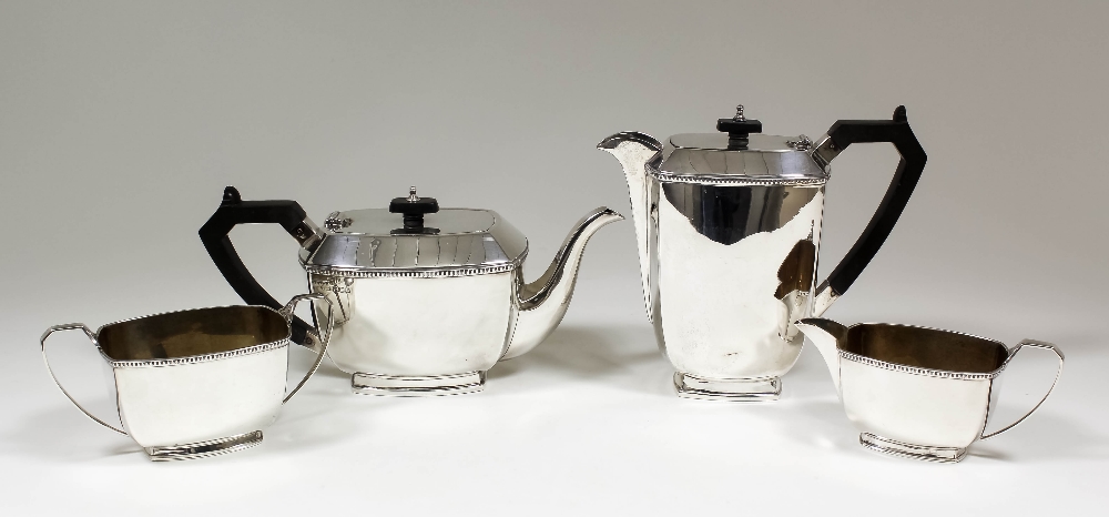 A George VI silver rectangular four piece tea service with bead mounts and angular handles,