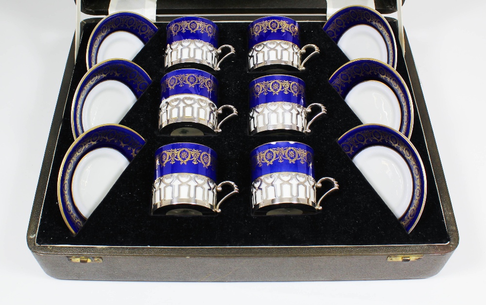 A set of six George VI silver mounted Coalport blue and gilt bordered porcelain  coffee cans, the