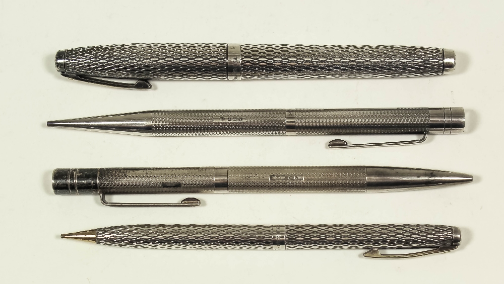 An Elizabeth II silver propelling pencil and matching ballpoint pen with engine turned ornament,