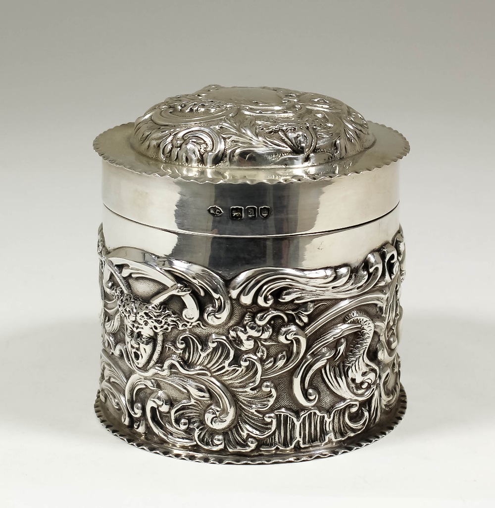 A late Victorian silver cylindrical box and cover embossed with masks, flowers and scroll work, 3.