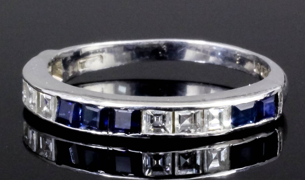 A modern 18ct white gold mounted sapphire and diamond set half hoop eternity ring, the face set with