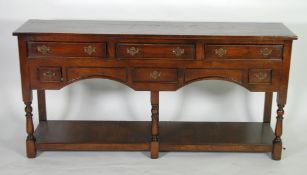 MODERN OAK DRESSER IN THE EIGHTEENTH CENTURY STYLE, the oblong top above six cockbeaded drawers,