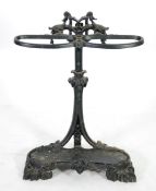 BLACK PAINTED CAST IRON STICK STAND, with two oval holders issued by a leaf cast back supports and