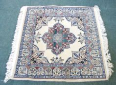 SMALL EASTERN RUG, finely knotted, the cream field having a large petal petal shaped centre