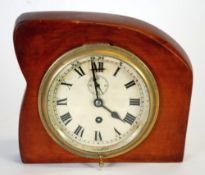 AN EARLY TWENTIETH CENTURY BRASS CASED SHIPS CLOCK, in later wooden surround