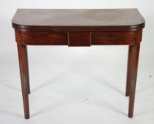 *EARLY NINETEENTH CENTURY LINE INLAID MAHOGANY FOLD OVER TEA TABLE, the rounded oblong top with
